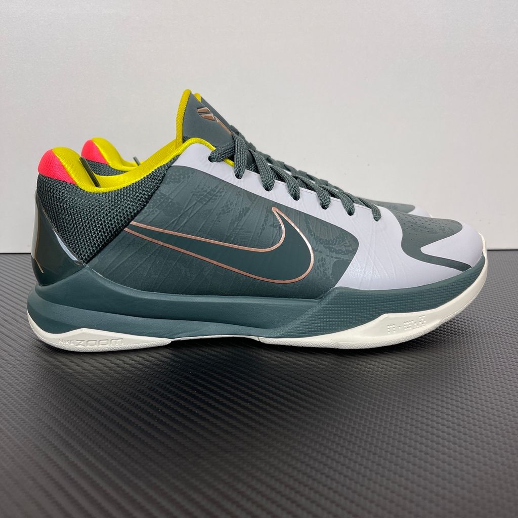 Side profile of the Nike Kobe 5 Protro sneaker CD4991-300 in the EYBL Girls colorway, featuring a dark forest green synthetic upper, a metallic red bronze Swoosh, and the EYBL logo on the tongue. Available in Singapore and Malaysia..jpg