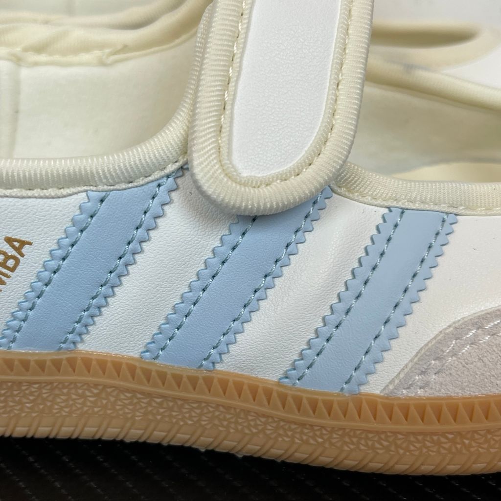 Side profile of the adidas Samba Jane White Blue Gum Women's sneaker JR7339, featuring a clean white leather upper, vibrant blue serrated 3-Stripes, an adjustable midfoot strap, and a classic gum rubber outsole. Available in Singapore and Malaysia..jpg