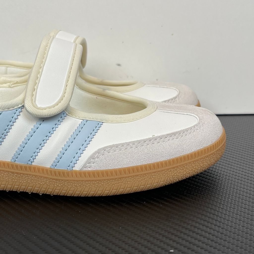 Side profile of the adidas Samba Jane White Blue Gum Women's sneaker JR7339, featuring a clean white leather upper, vibrant blue serrated 3-Stripes, an adjustable midfoot strap, and a classic gum rubber outsole. Available in Singapore and Malaysia..jpg