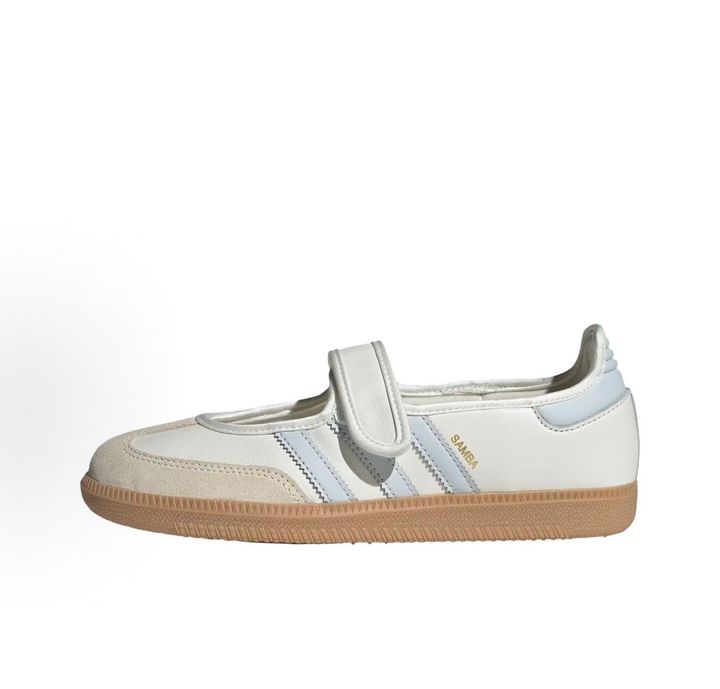 Side profile of the adidas Samba Jane White Blue Gum Women's sneaker JR7339, featuring a clean white leather upper, vibrant blue serrated 3-Stripes, an adjustable midfoot strap, and a classic gum rubber outsole. Available in Singapore and Malaysia..pic_hd
