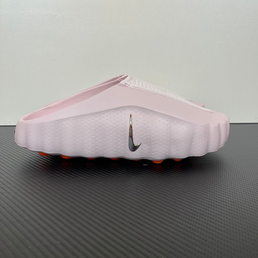 Side profile of the Nike Mind 001 Slide HQ4307-610 in Pearl Pink, featuring a seamless, ergonomic foam design, subtle Nike branding, and a textured footbed. Available in Singapore and Malaysia.