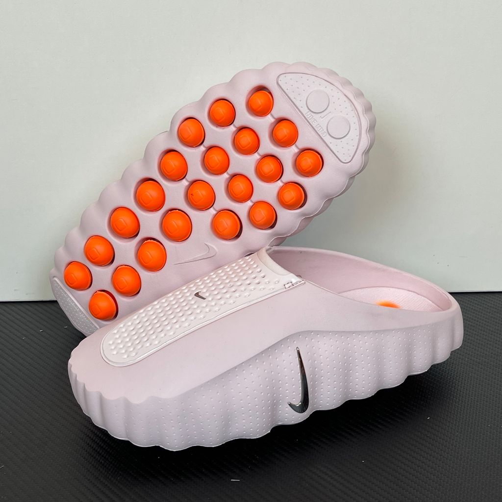 Side profile of the Nike Mind 001 Slide HQ4307-610 in Pearl Pink, featuring a seamless, ergonomic foam design, subtle Nike branding, and a textured footbed. Available in Singapore and Malaysia.