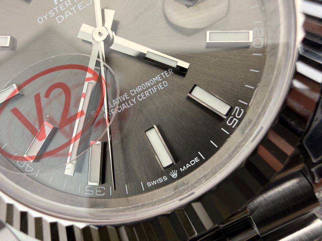 Front view of the Rolex Datejust 41 timepiece reference M126334-0014, featuring a slate sunray dial, an 18ct white gold fluted bezel, a date window with Cyclops lens, and an Oystersteel Jubilee bracelet. Available in Singapore and Malaysia..jpg