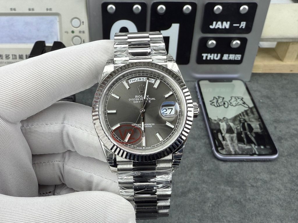 Front view of the Rolex Day-Date 40 timepiece reference M228239-0060, crafted entirely in solid 18ct white gold, featuring a slate sunray dial, baton hour markers, a fluted bezel, and the iconic President bracelet. Available in Singapore and Malaysia.