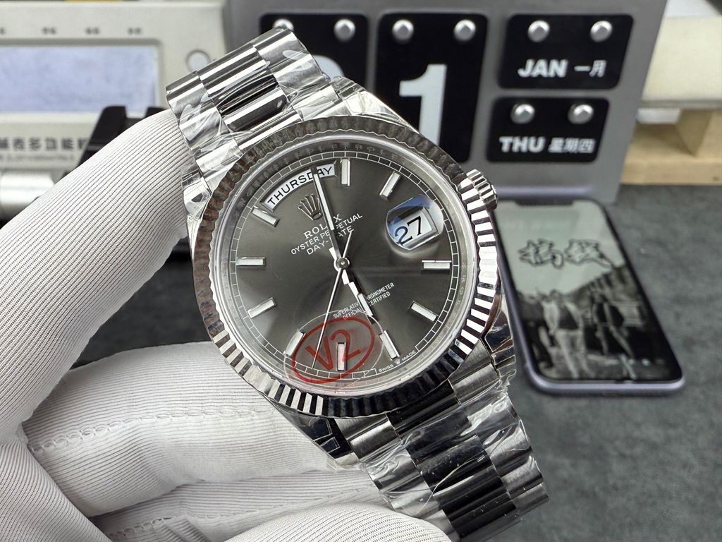 Front view of the Rolex Day-Date 40 timepiece reference M228239-0060, crafted entirely in solid 18ct white gold, featuring a slate sunray dial, baton hour markers, a fluted bezel, and the iconic President bracelet. Available in Singapore and Malaysia..jpg