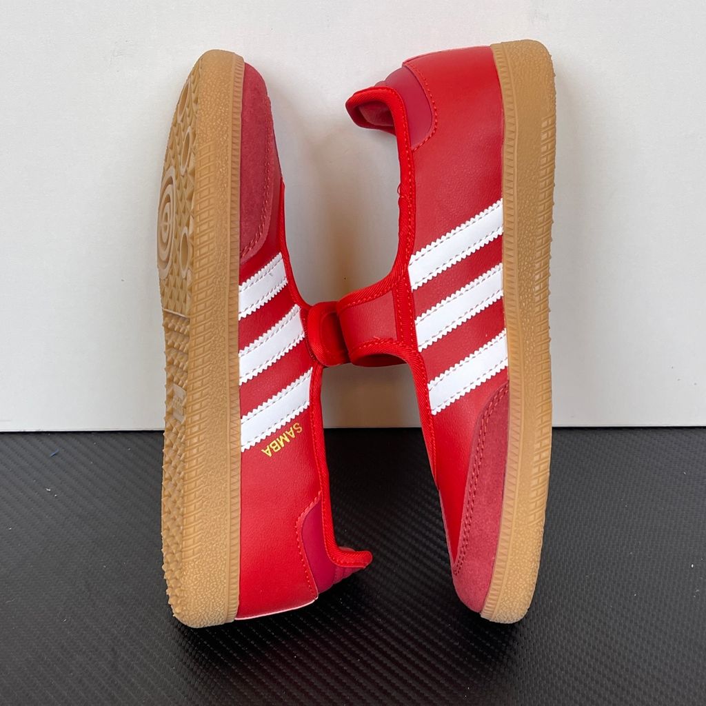 Side profile of the adidas Samba Jane Scarlet White Gum Women's sneaker JQ6446, featuring a vibrant red leather upper, crisp white serrated 3-Stripes, an adjustable midfoot strap, and a classic gum rubber outsole. Available in Singapore and Malaysia.