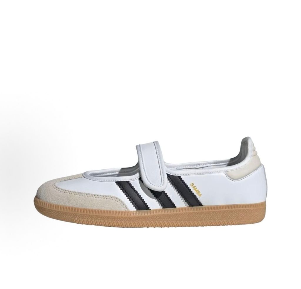 Side profile of the adidas Samba Jane White Black Gum Women's sneaker JR1402, featuring a crisp white leather upper, black serrated 3-Stripes, an adjustable midfoot strap, and a classic gum rubber outsole. Available in Singapore and Malaysia.