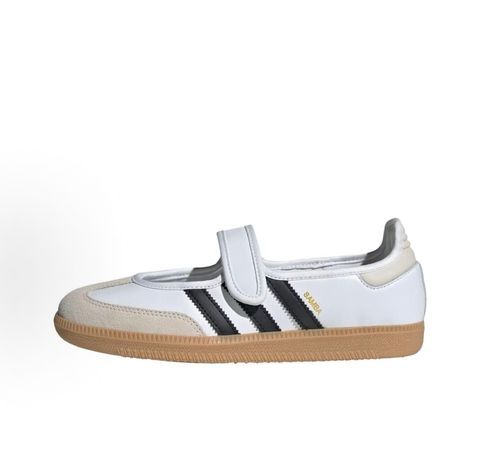 Side profile of the adidas Samba Jane White Black Gum Women's sneaker JR1402, featuring a crisp white leather upper, black serrated 3-Stripes, an adjustable midfoot strap, and a classic gum rubber outsole. Available in Singapore and Malaysia.