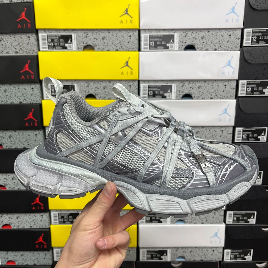 Side profile of the Balenciaga Women's Triple S.2 Gradient Sneaker 865851WTR2G6800, featuring a chunky, complex three-layered rubber sole, a worn-out gradient purple polyurethane and mesh upper, and bicolor hiking laces.