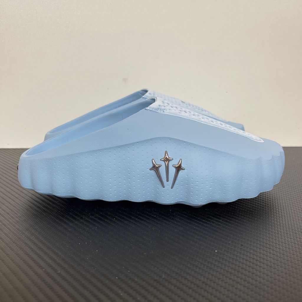 Shop the authentic NOCTA x Nike Mind 001 "Ice Blue." Featuring premium foam cushioning, chrome North Star hardware, and a futuristic sculpted design. Add to cart for the ultimate luxury slide staple perfect for the SG & MY urban lifestyle.