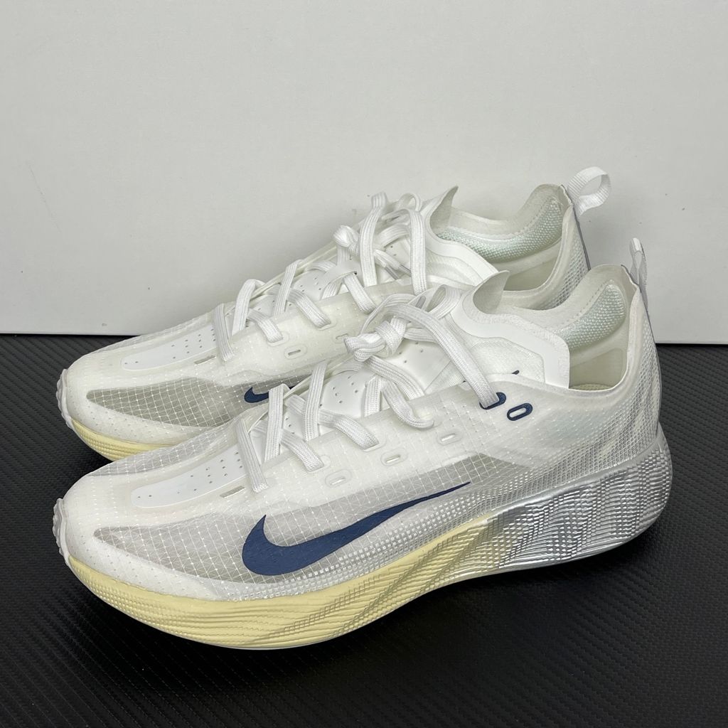 Nike Ava X retro running sneaker in Metallic Silver, Alabaster, and Midnight Navy, featuring a breathable mesh upper and responsive Cushlon midsole, SKU HM9697-003.