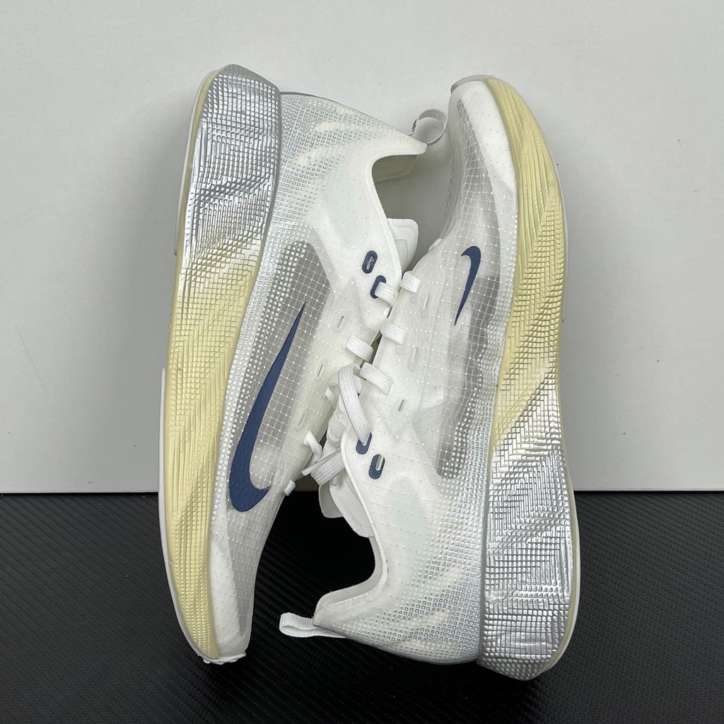 Nike Ava X retro running sneaker in Metallic Silver, Alabaster, and Midnight Navy, featuring a breathable mesh upper and responsive Cushlon midsole, SKU HM9697-003.