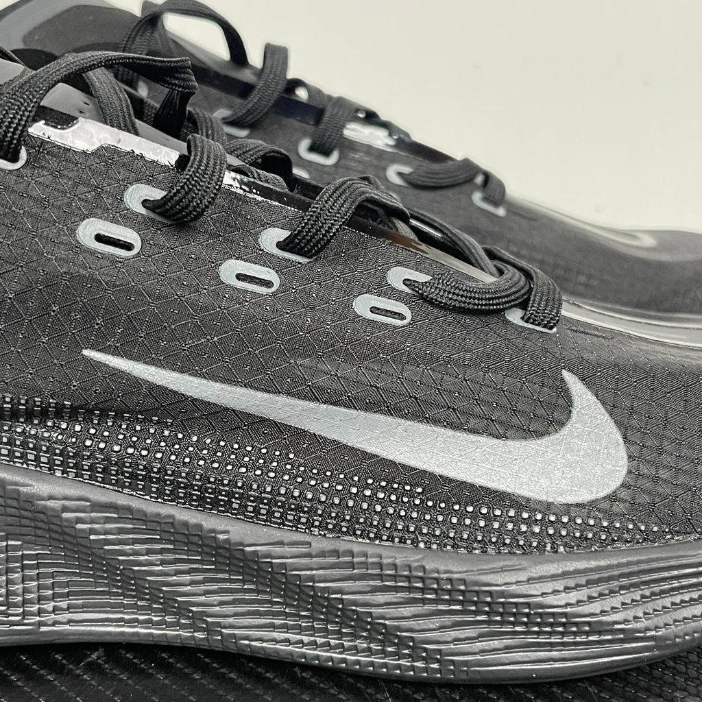 Nike Ava X lightweight running sneaker in stealth Black and Anthracite, featuring a breathable mesh upper and blacked-out Cushlon midsole, SKU HM9697-004.