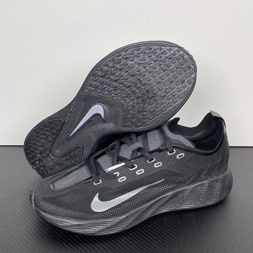Nike Ava X lightweight running sneaker in stealth Black and Anthracite, featuring a breathable mesh upper and blacked-out Cushlon midsole, SKU HM9697-004.