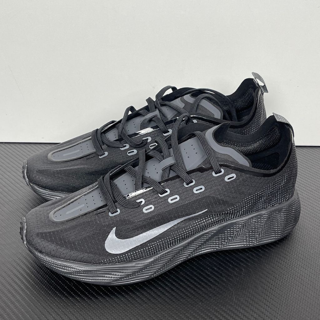 Nike Ava X lightweight running sneaker in stealth Black and Anthracite, featuring a breathable mesh upper and blacked-out Cushlon midsole, SKU HM9697-004.