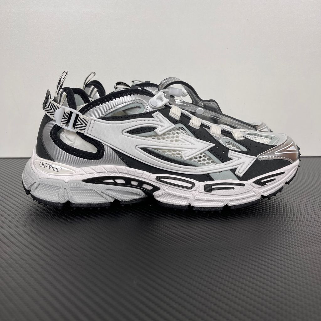 Authentic Off-White Be Right Back (BRB) sneaker in metallic silver, white, and black, featuring a technical mesh base and the signature Off-White Arrow logo on the lateral side, SKU OMIA29SS26FAB0017210.