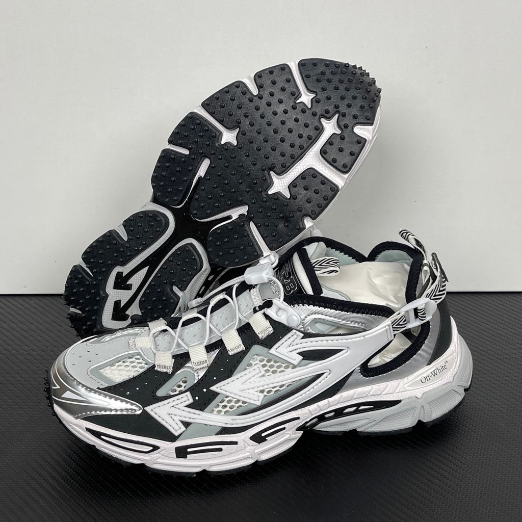 Authentic Off-White Be Right Back (BRB) sneaker in metallic silver, white, and black, featuring a technical mesh base and the signature Off-White Arrow logo on the lateral side, SKU OMIA29SS26FAB0017210.