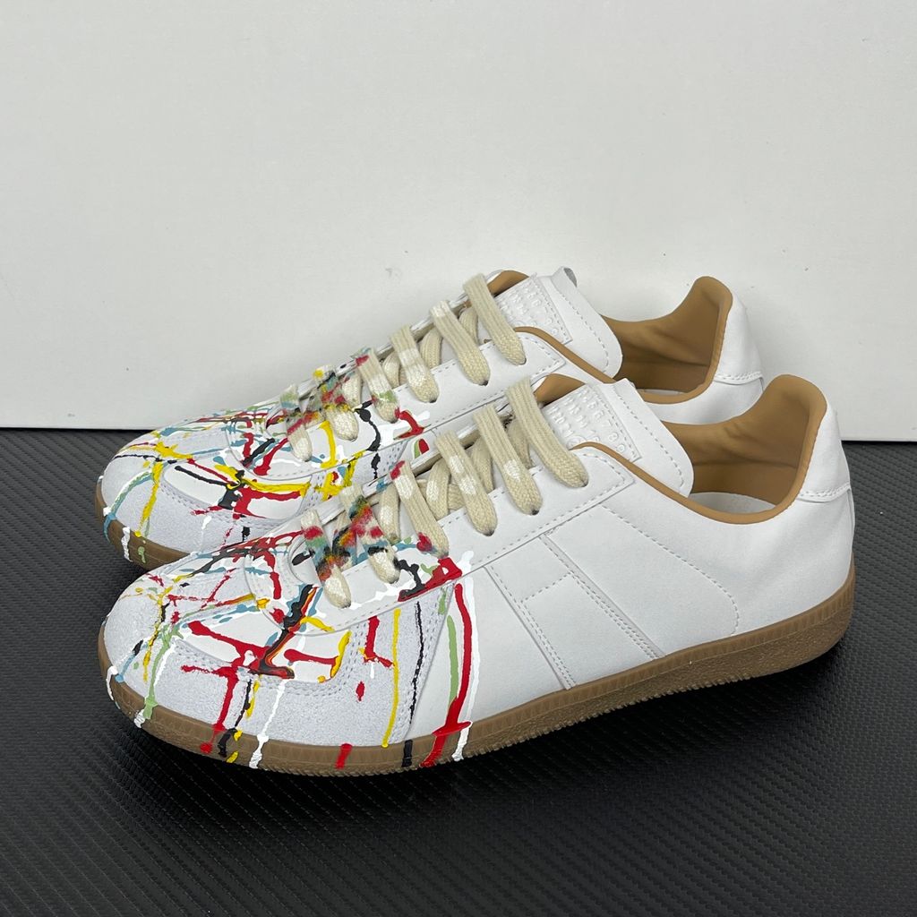 Shop the luxury Maison Margiela Replica 'Paint Drop' in White Calfskin (S58WS0109P1895T1016). Featuring hand-splattered multicolor paint and a classic gum sole. Fast worldwide shipping.
