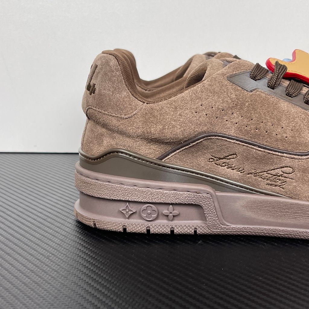 Tyler, The Creator x Louis Vuitton LV Trainer in deep brown suede, featuring the signature Louis Vuitton script on the side panel, monogram flowers on the midsole, and a custom colorful wavy lace tag..jpg
