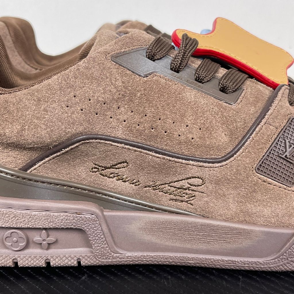 Tyler, The Creator x Louis Vuitton LV Trainer in deep brown suede, featuring the signature Louis Vuitton script on the side panel, monogram flowers on the midsole, and a custom colorful wavy lace tag..jpg