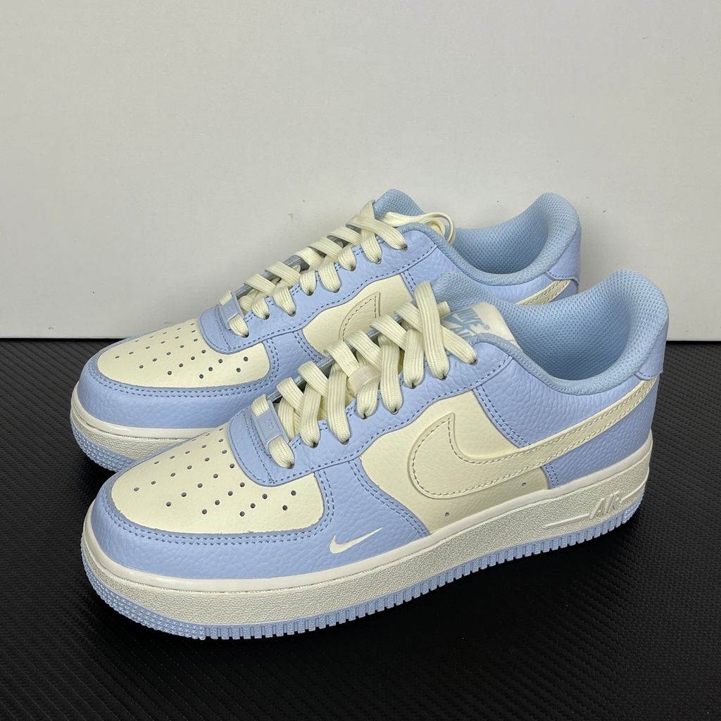 Nike Women's Air Force 1 '07 sneaker in Hydrogen Blue and Soft Pearl, featuring textured tumbled leather overlays, a cream Swoosh, and a mini embroidered Swoosh, SKU IV3222-400.