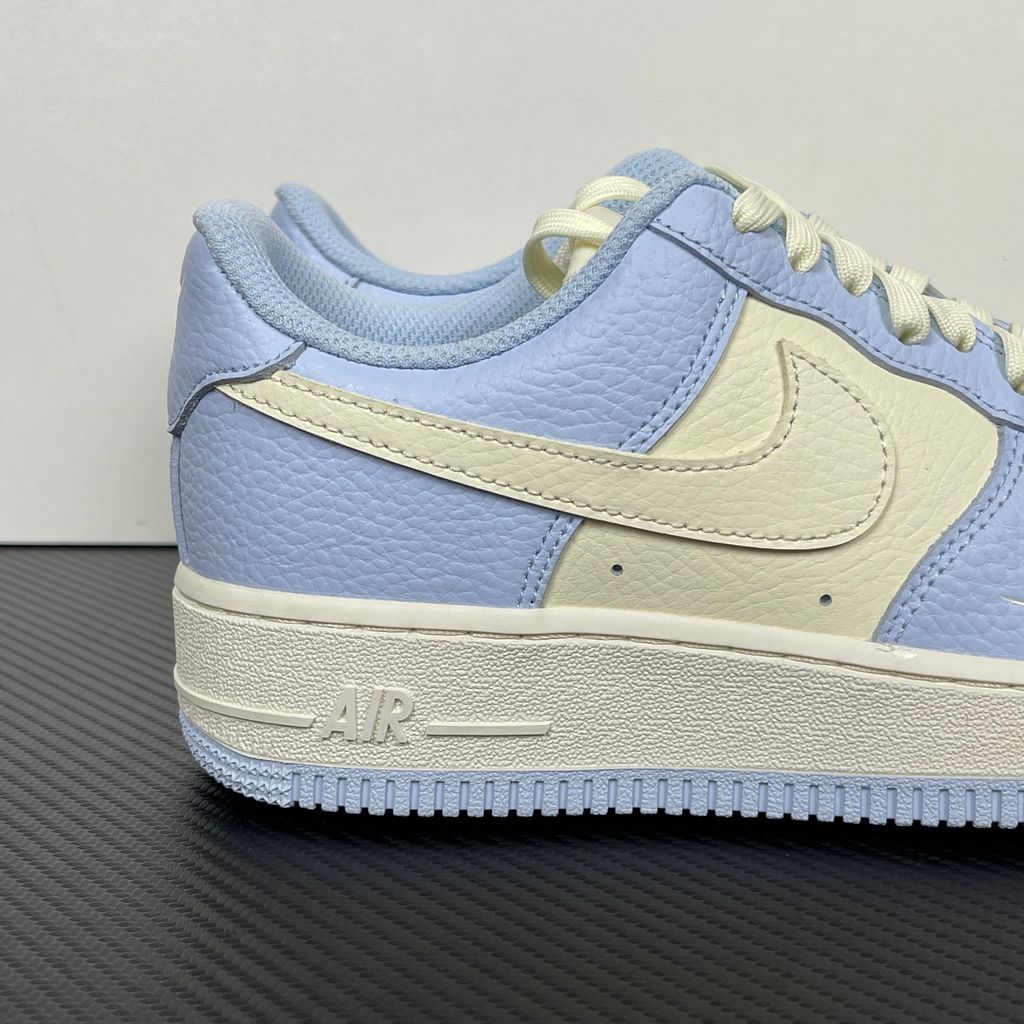 Nike Women's Air Force 1 '07 sneaker in Hydrogen Blue and Soft Pearl, featuring textured tumbled leather overlays, a cream Swoosh, and a mini embroidered Swoosh, SKU IV3222-400.