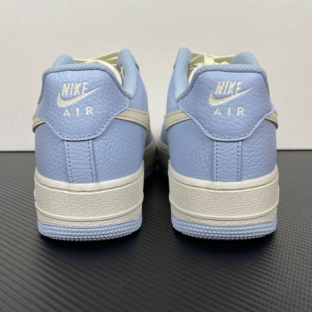 Nike Women's Air Force 1 '07 sneaker in Hydrogen Blue and Soft Pearl, featuring textured tumbled leather overlays, a cream Swoosh, and a mini embroidered Swoosh, SKU IV3222-400.