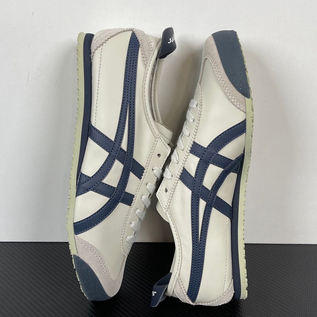 Onitsuka Tiger Mexico 66 vintage running sneaker in Birch and Peacoat navy, featuring a cream leather upper and signature side stripes, SKU 1183C102-200.