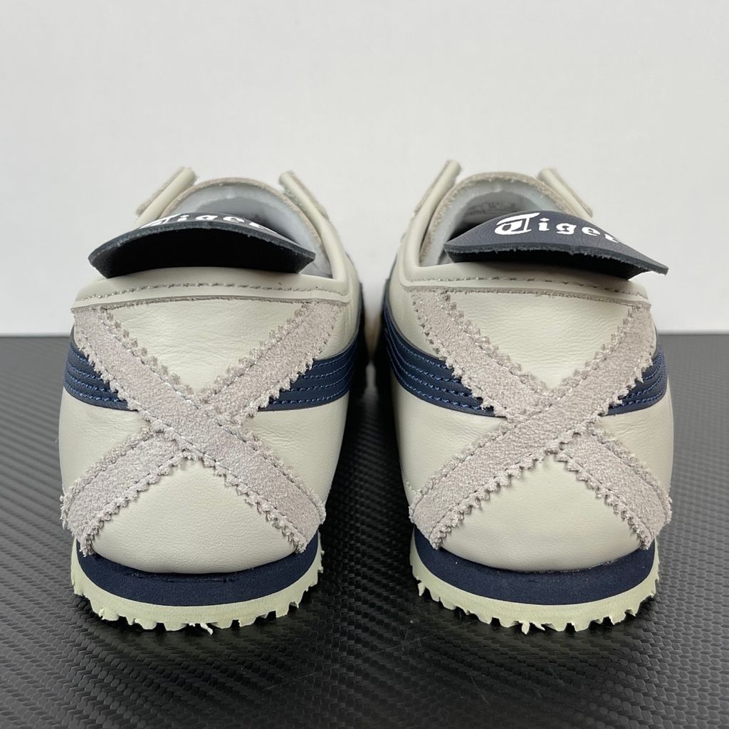 Onitsuka Tiger Mexico 66 vintage running sneaker in Birch and Peacoat navy, featuring a cream leather upper and signature side stripes, SKU 1183C102-200.