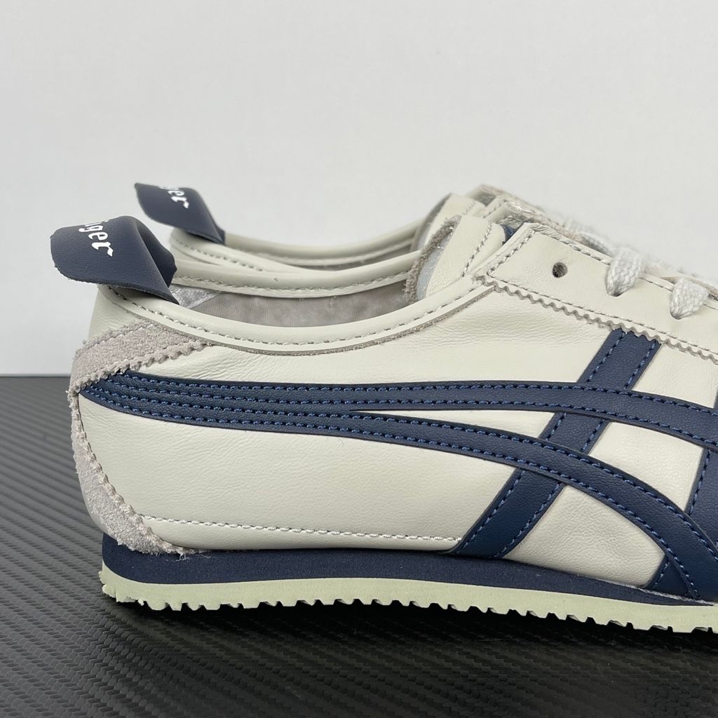 Onitsuka Tiger Mexico 66 vintage running sneaker in Birch and Peacoat navy, featuring a cream leather upper and signature side stripes, SKU 1183C102-200.