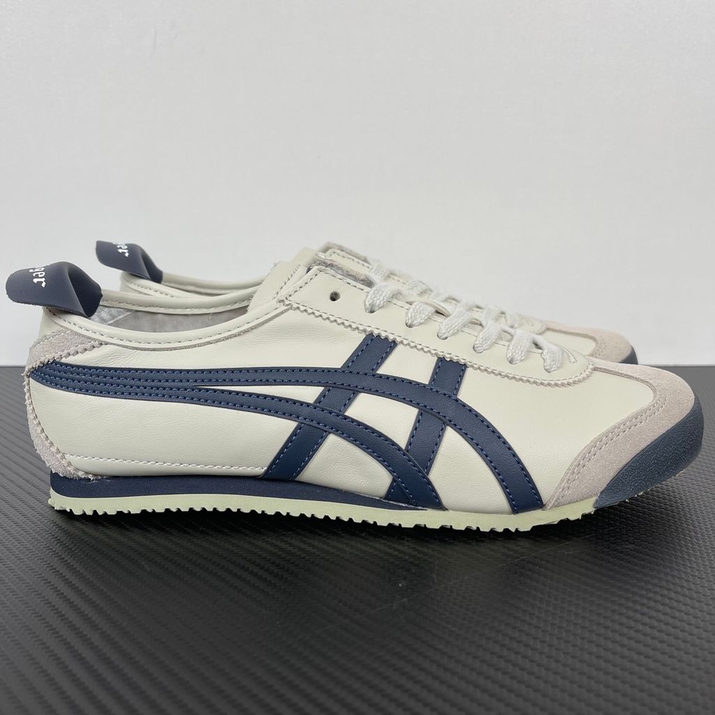 Onitsuka Tiger Mexico 66 vintage running sneaker in Birch and Peacoat navy, featuring a cream leather upper and signature side stripes, SKU 1183C102-200.