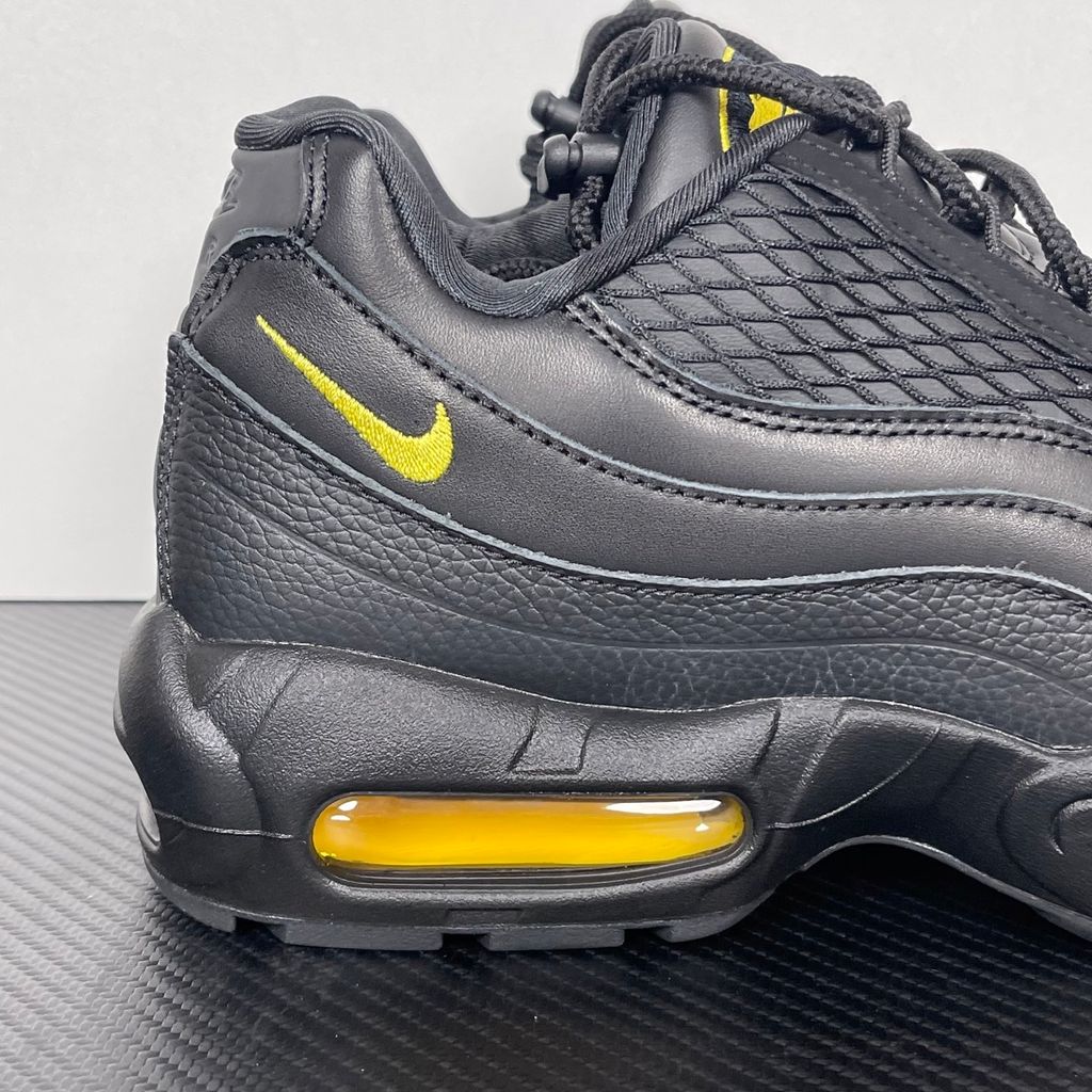 Limited edition Nike Air Max 95 x Corteiz (CRTZ RTW) sneaker in Honey and Black, featuring premium leather overlays, netted mesh, and visible Air units, SKU FB2709-003.