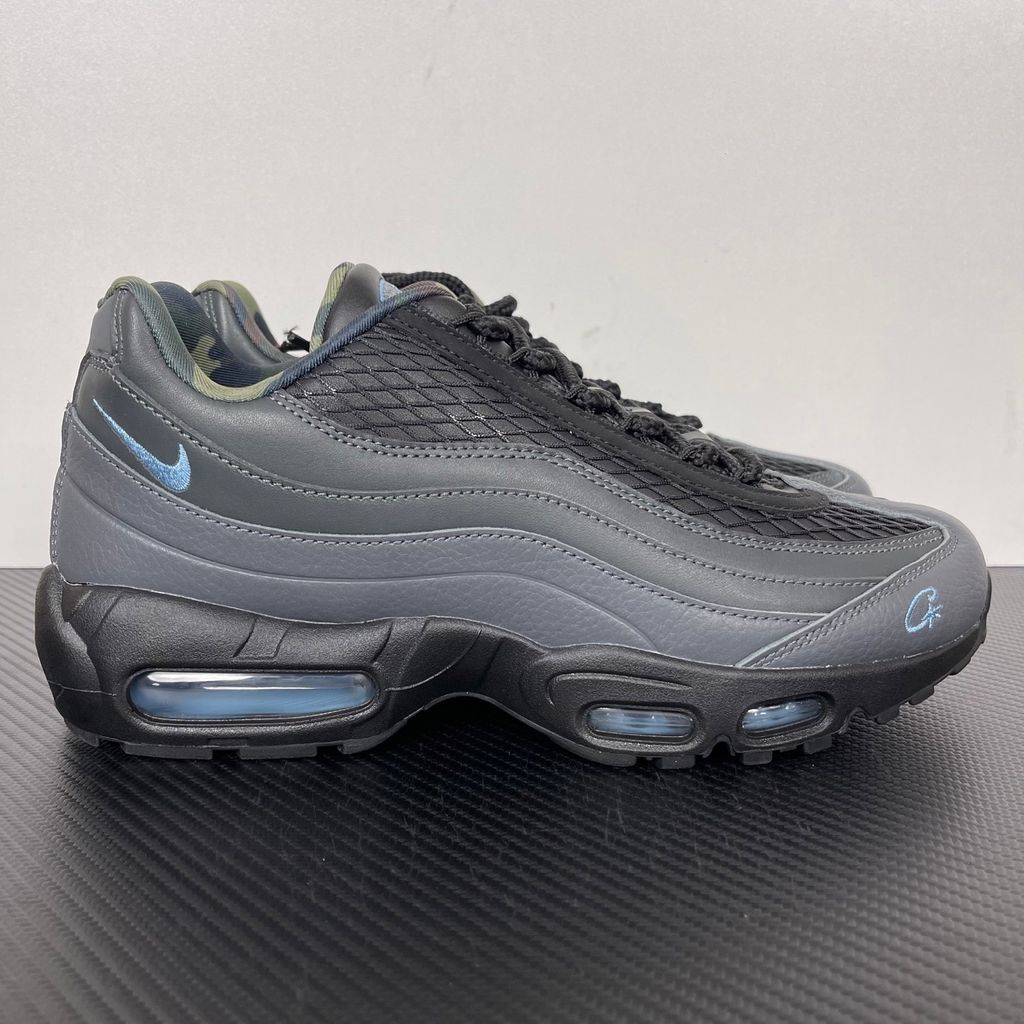 Limited edition Nike Air Max 95 SP x Corteiz (CRTZ RTW) sneaker in Black and Aegean Storm, featuring premium leather overlays, netted mesh, and crisp blue visible Air units, SKU FB2709-002.