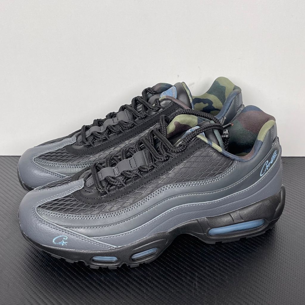 Limited edition Nike Air Max 95 SP x Corteiz (CRTZ RTW) sneaker in Black and Aegean Storm, featuring premium leather overlays, netted mesh, and crisp blue visible Air units, SKU FB2709-002.