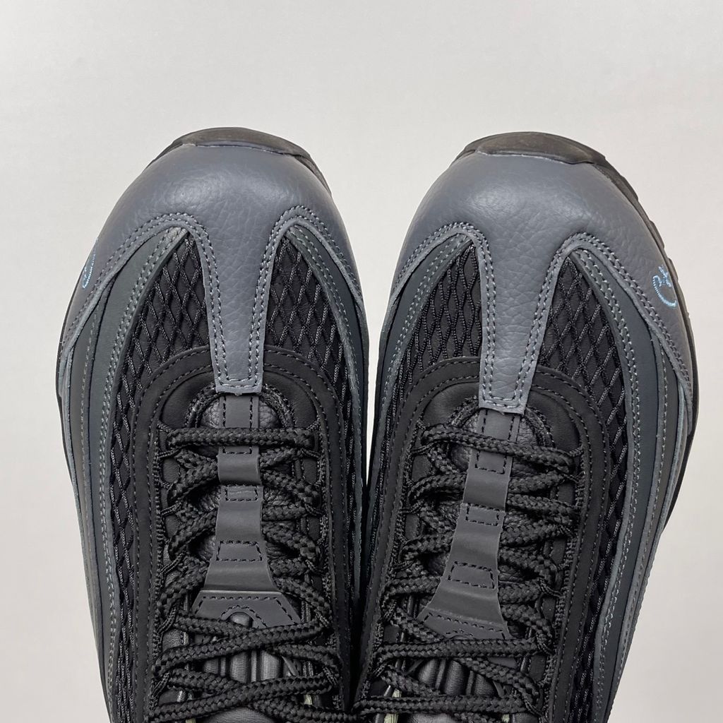 Limited edition Nike Air Max 95 SP x Corteiz (CRTZ RTW) sneaker in Black and Aegean Storm, featuring premium leather overlays, netted mesh, and crisp blue visible Air units, SKU FB2709-002.