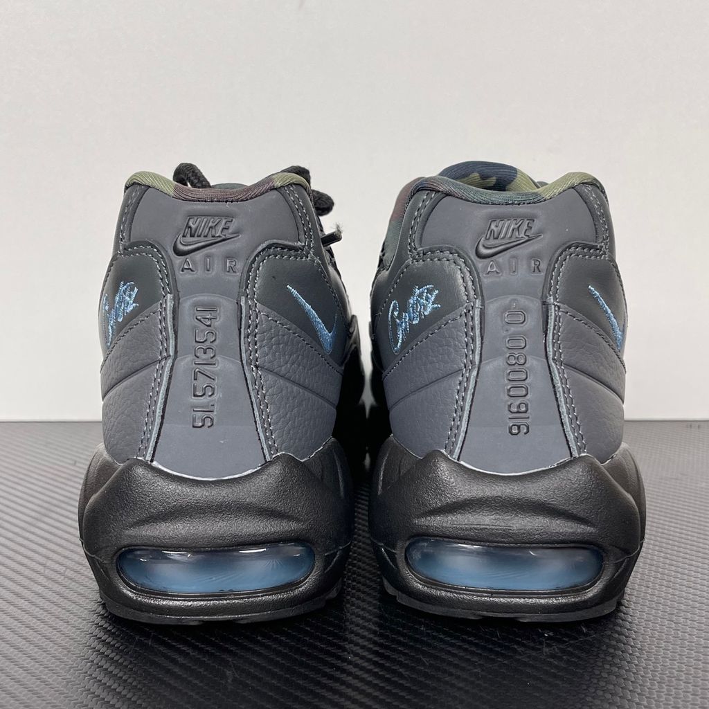 Limited edition Nike Air Max 95 SP x Corteiz (CRTZ RTW) sneaker in Black and Aegean Storm, featuring premium leather overlays, netted mesh, and crisp blue visible Air units, SKU FB2709-002.