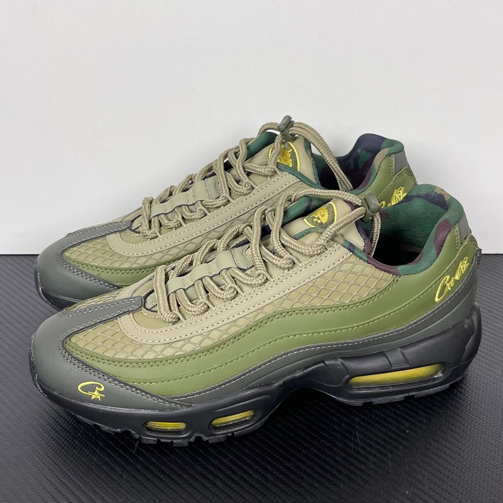 Limited edition Nike Air Max 95 SP x Corteiz (CRTZ RTW) sneaker in Gutta Green and Black, featuring premium olive leather overlays, netted mesh, and vibrant yellow visible Air units, SKU FB2709-300.