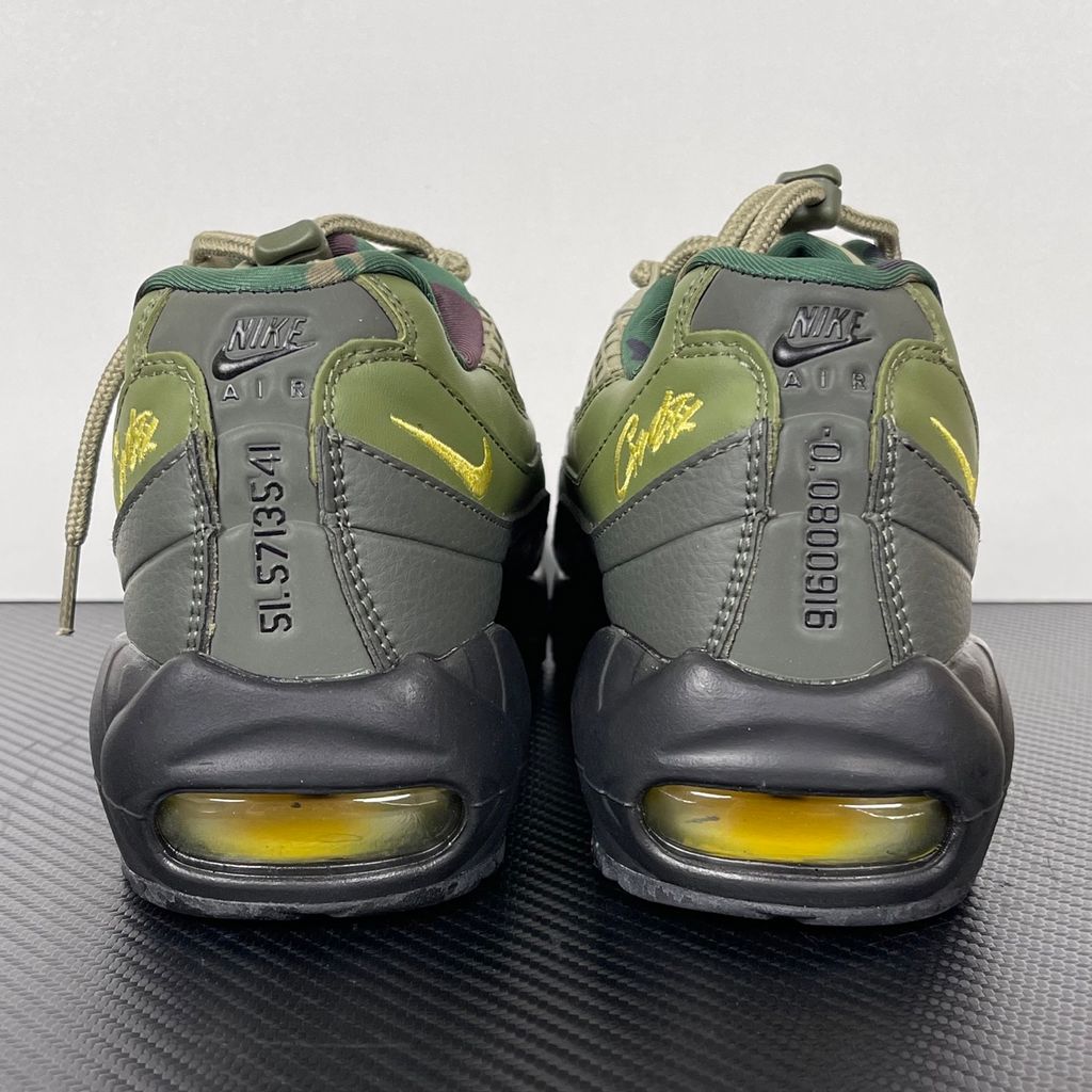 Limited edition Nike Air Max 95 SP x Corteiz (CRTZ RTW) sneaker in Gutta Green and Black, featuring premium olive leather overlays, netted mesh, and vibrant yellow visible Air units, SKU FB2709-300.