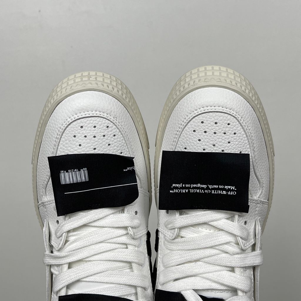 Off-White 3.0 Off Court Low sneaker in pure white tumbled calfskin leather, featuring black industrial label detailing, classic Off-White side typography, and a thick ribbed rubber midsole, SKU 0010110.