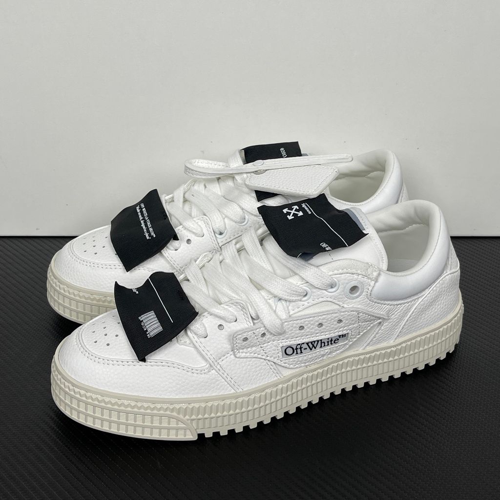 Off-White 3.0 Off Court Low sneaker in pure white tumbled calfskin leather, featuring black industrial label detailing, classic Off-White side typography, and a thick ribbed rubber midsole, SKU 0010110.