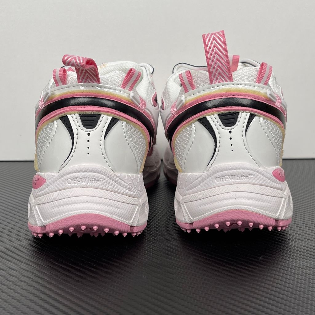 Off-White Be Right Back runner sneaker in a white, pink, and black colorway, featuring breathable mesh, dynamic synthetic overlays, the signature arrow logo, and a white zip-tie tag.
