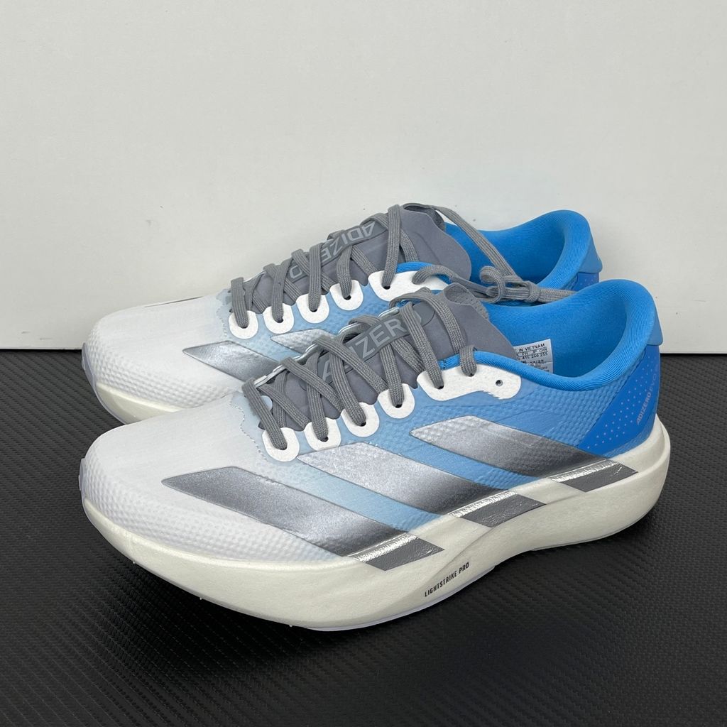 adidas Adizero Evo SL Woven marathon running shoe in a Cloud Blue and White gradient, featuring metallic silver Three Stripes and a thick Lightstrike Pro foam midsole, SKU KJ1996.