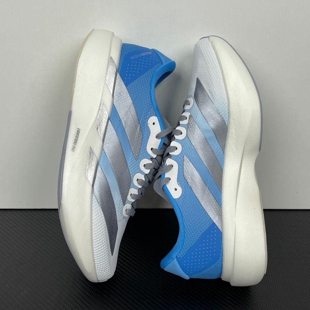 adidas Adizero Evo SL Woven marathon running shoe in a Cloud Blue and White gradient, featuring metallic silver Three Stripes and a thick Lightstrike Pro foam midsole, SKU KJ1996.