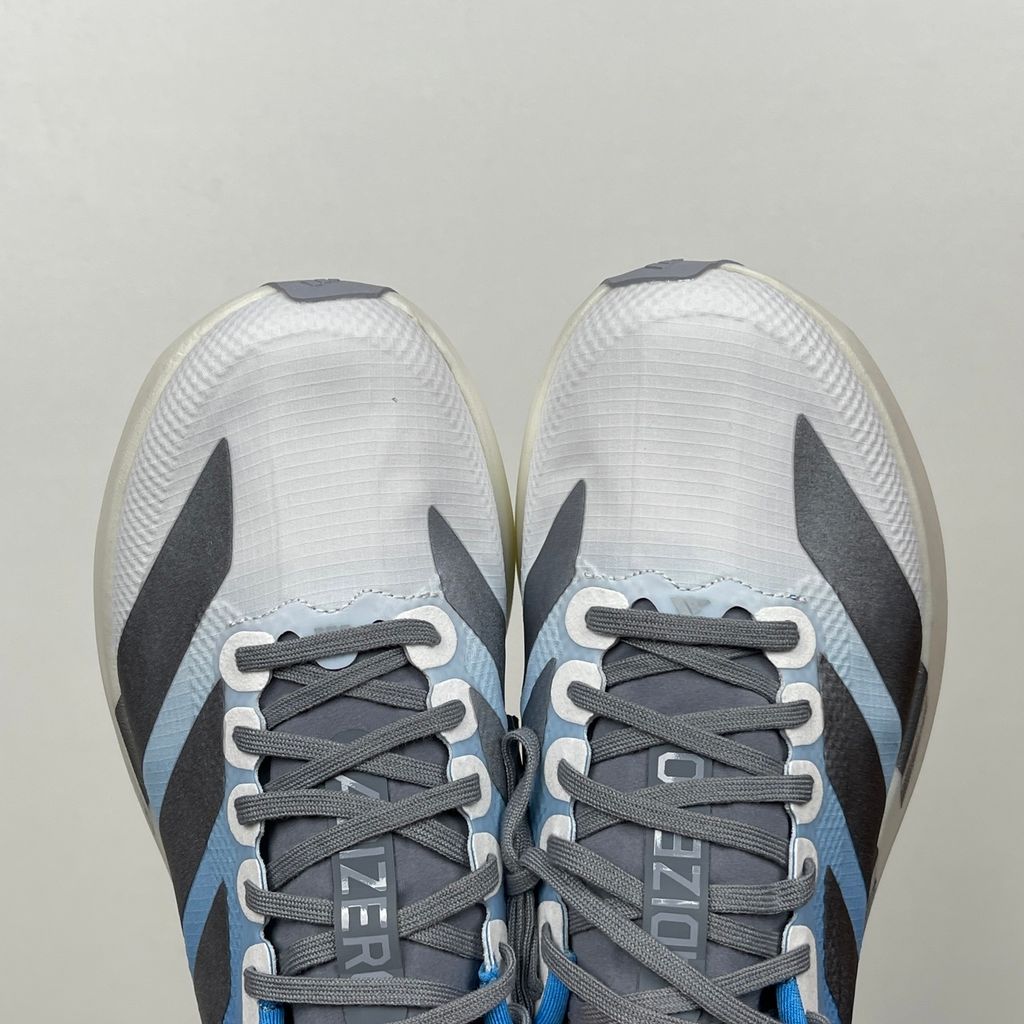 adidas Adizero Evo SL Woven marathon running shoe in a Cloud Blue and White gradient, featuring metallic silver Three Stripes and a thick Lightstrike Pro foam midsole, SKU KJ1996.