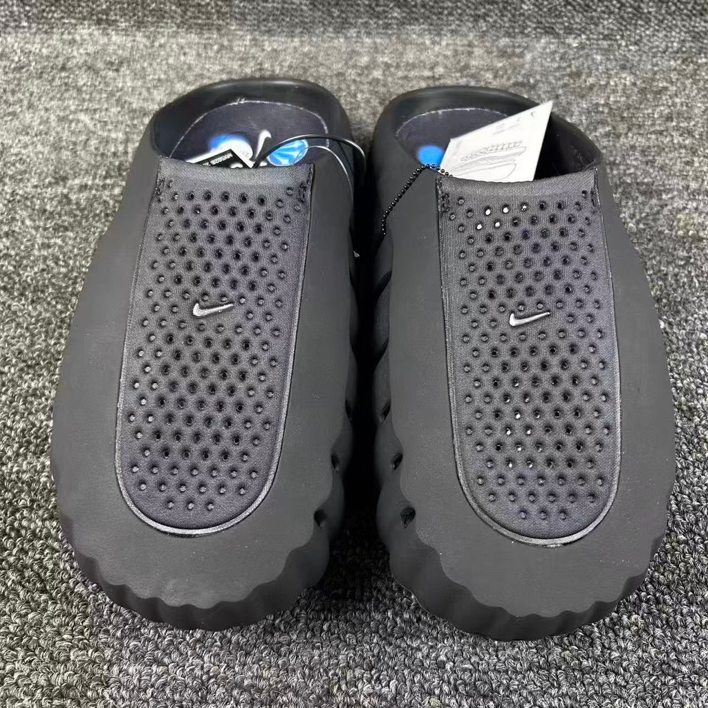 Nike x NOCTA Mind 001 premium lifestyle slide in all black, featuring a tactical, tech-wear inspired molded upper and subtle NOCTA branding.