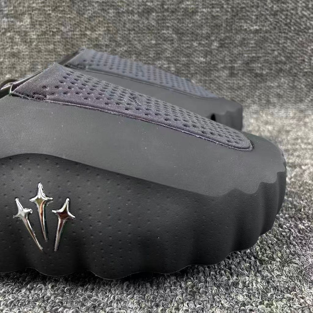 Nike x NOCTA Mind 001 premium lifestyle slide in all black, featuring a tactical, tech-wear inspired molded upper and subtle NOCTA branding.