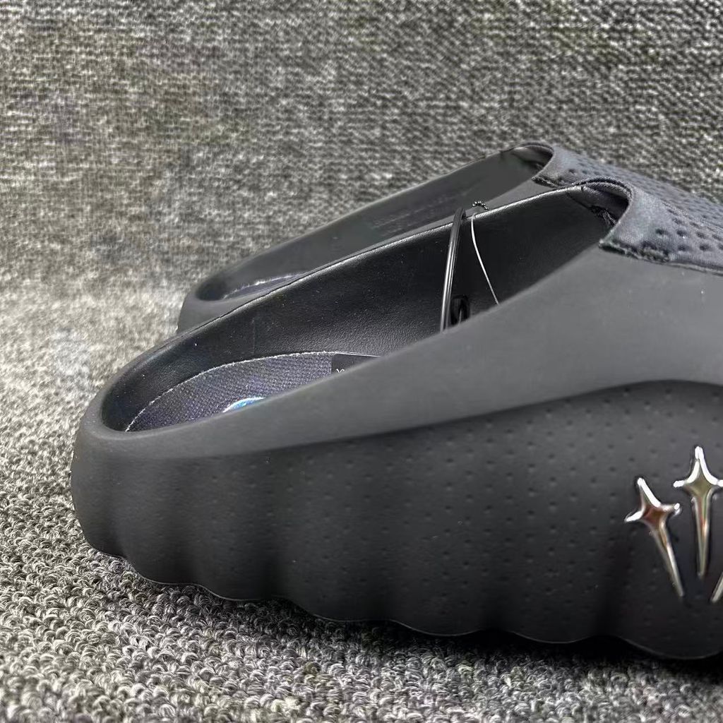 Nike x NOCTA Mind 001 premium lifestyle slide in all black, featuring a tactical, tech-wear inspired molded upper and subtle NOCTA branding.