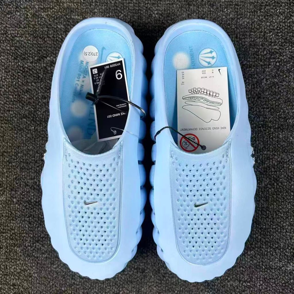 Nike x NOCTA Mind 001 premium lifestyle slide in a vibrant Ice Blue, featuring a tactical, tech-wear inspired molded upper and subtle NOCTA branding.