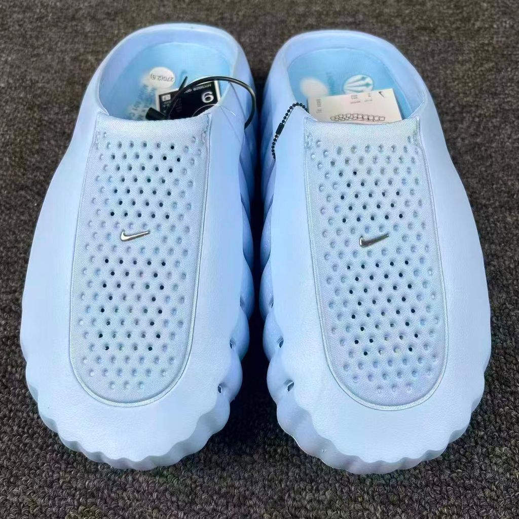 Nike x NOCTA Mind 001 premium lifestyle slide in a vibrant Ice Blue, featuring a tactical, tech-wear inspired molded upper and subtle NOCTA branding.