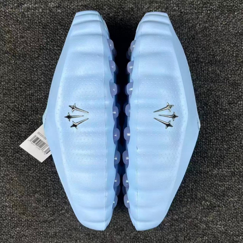 Nike x NOCTA Mind 001 premium lifestyle slide in a vibrant Ice Blue, featuring a tactical, tech-wear inspired molded upper and subtle NOCTA branding.
